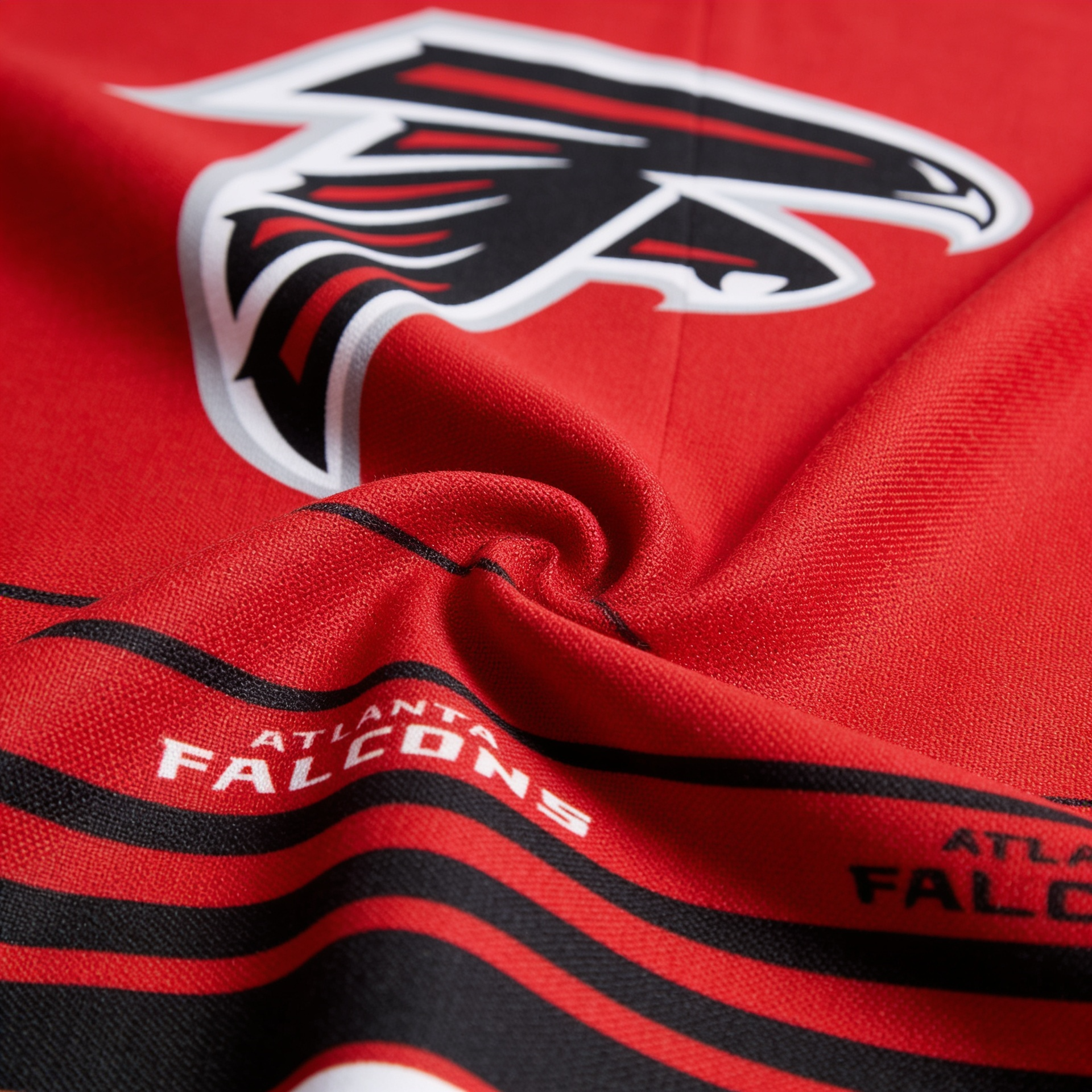 Close-up of Atlanta Falcons logo and text on a red background