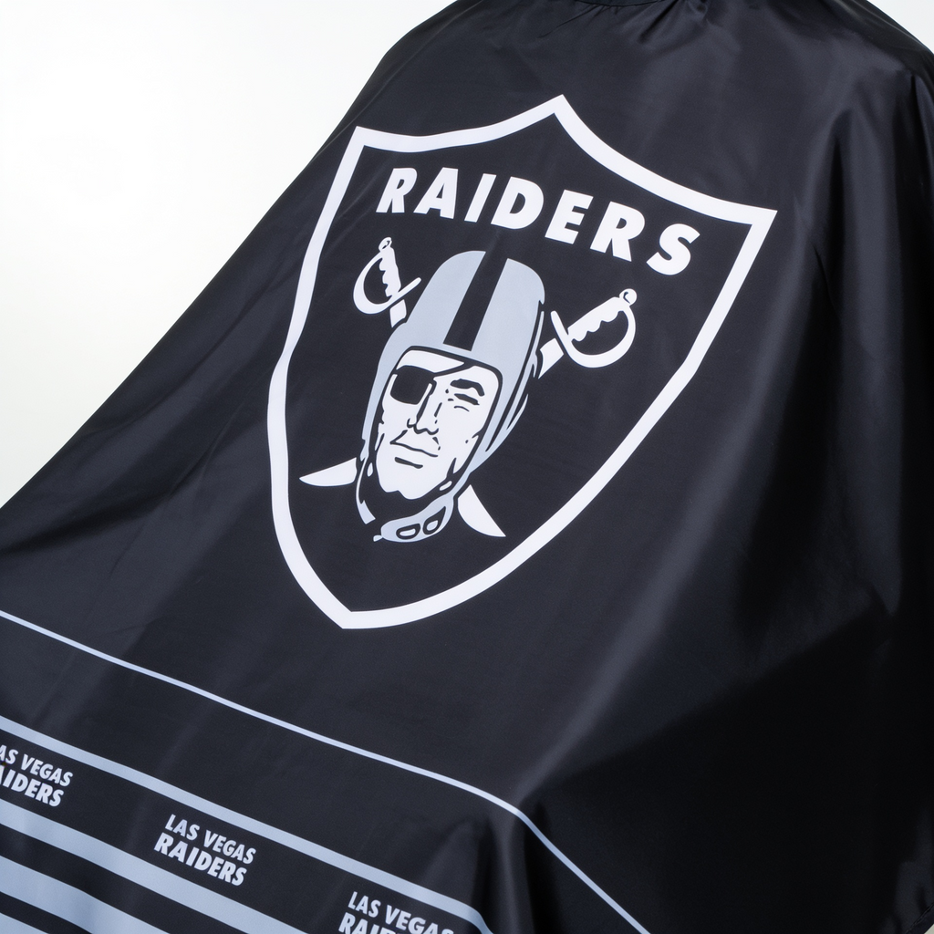 Black barber cape with Las Vegas Raiders logo and text on a white background