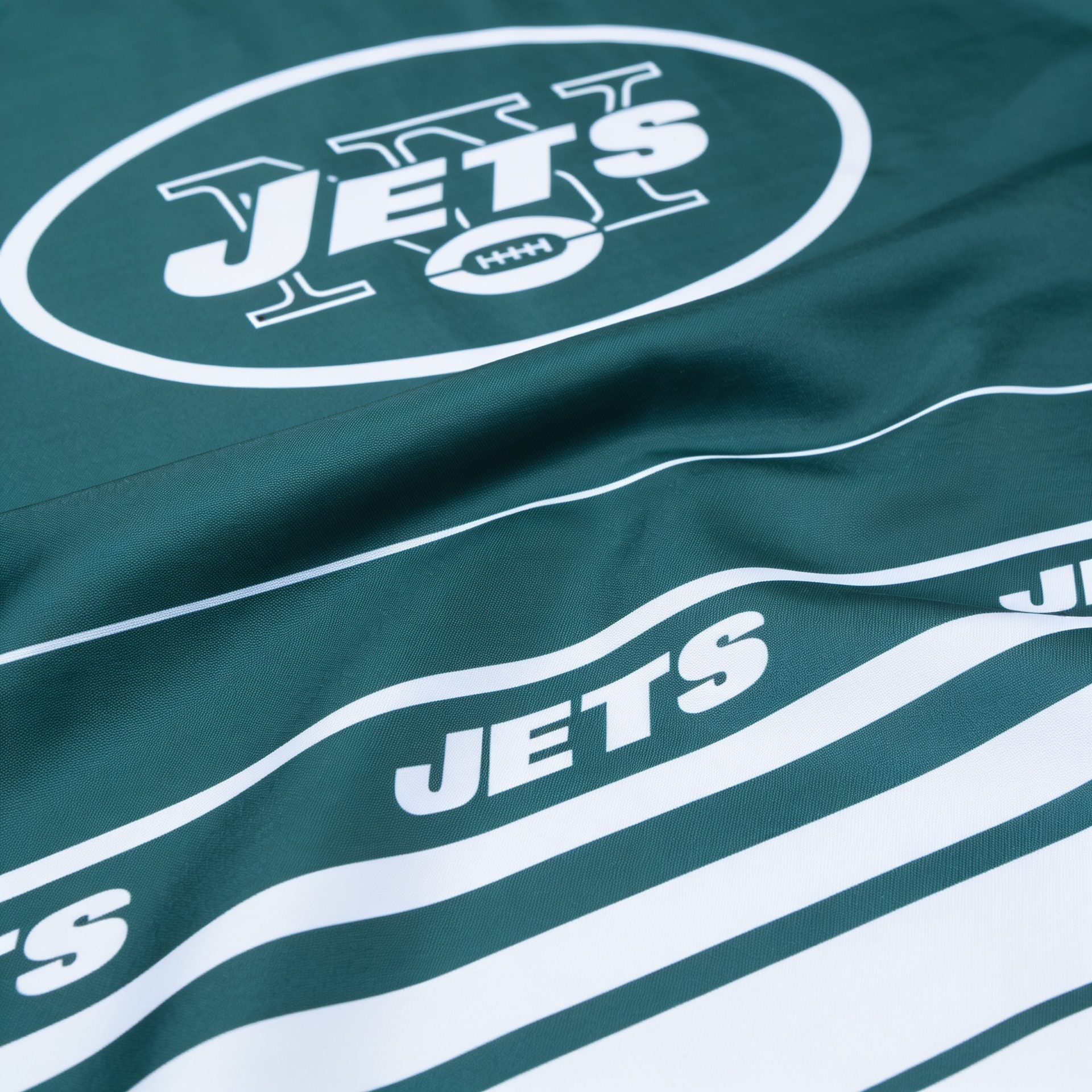 Green fabric with 'JETS' logo and text